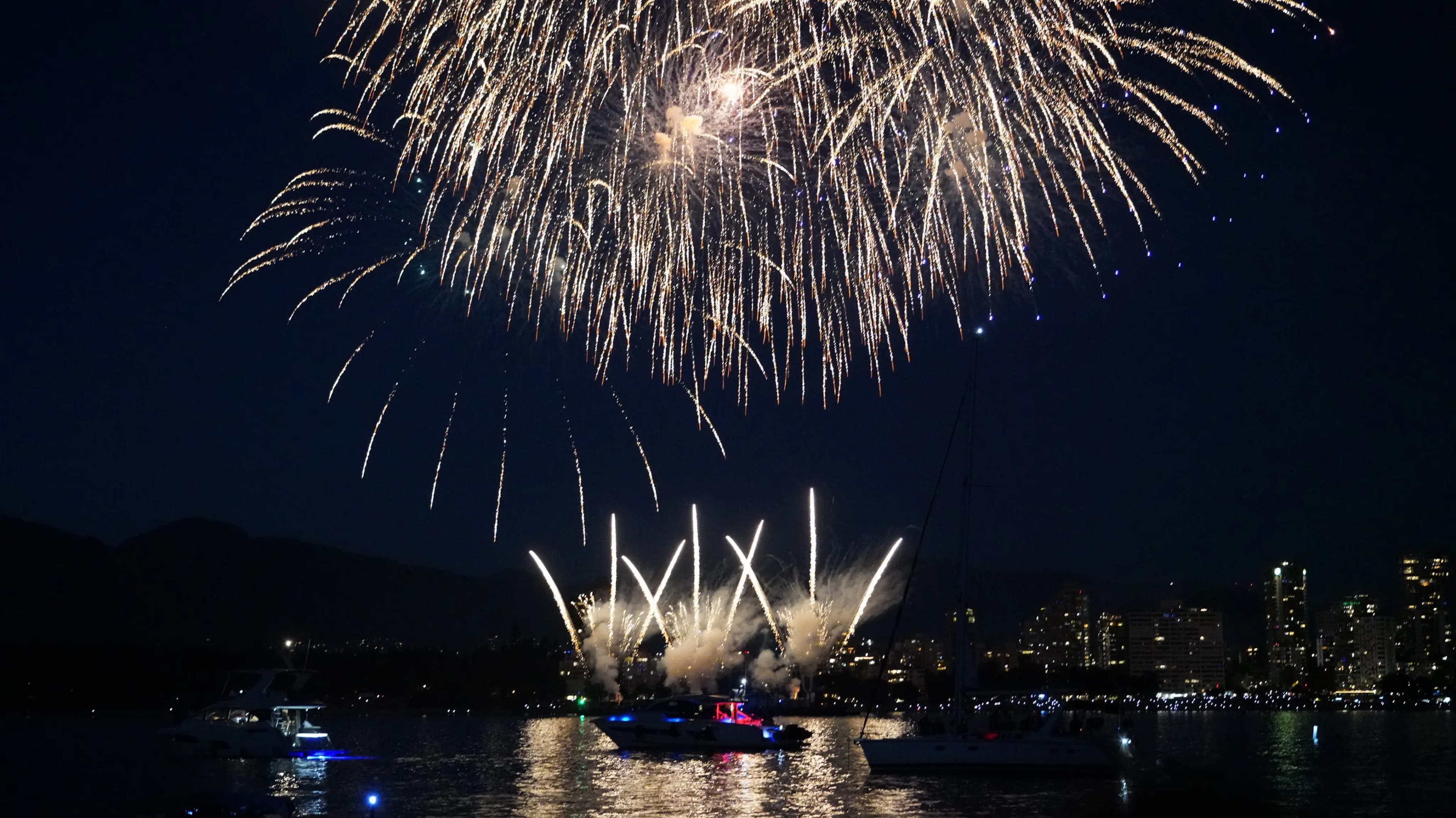 Fireworks over English Bay with yachts anchored below