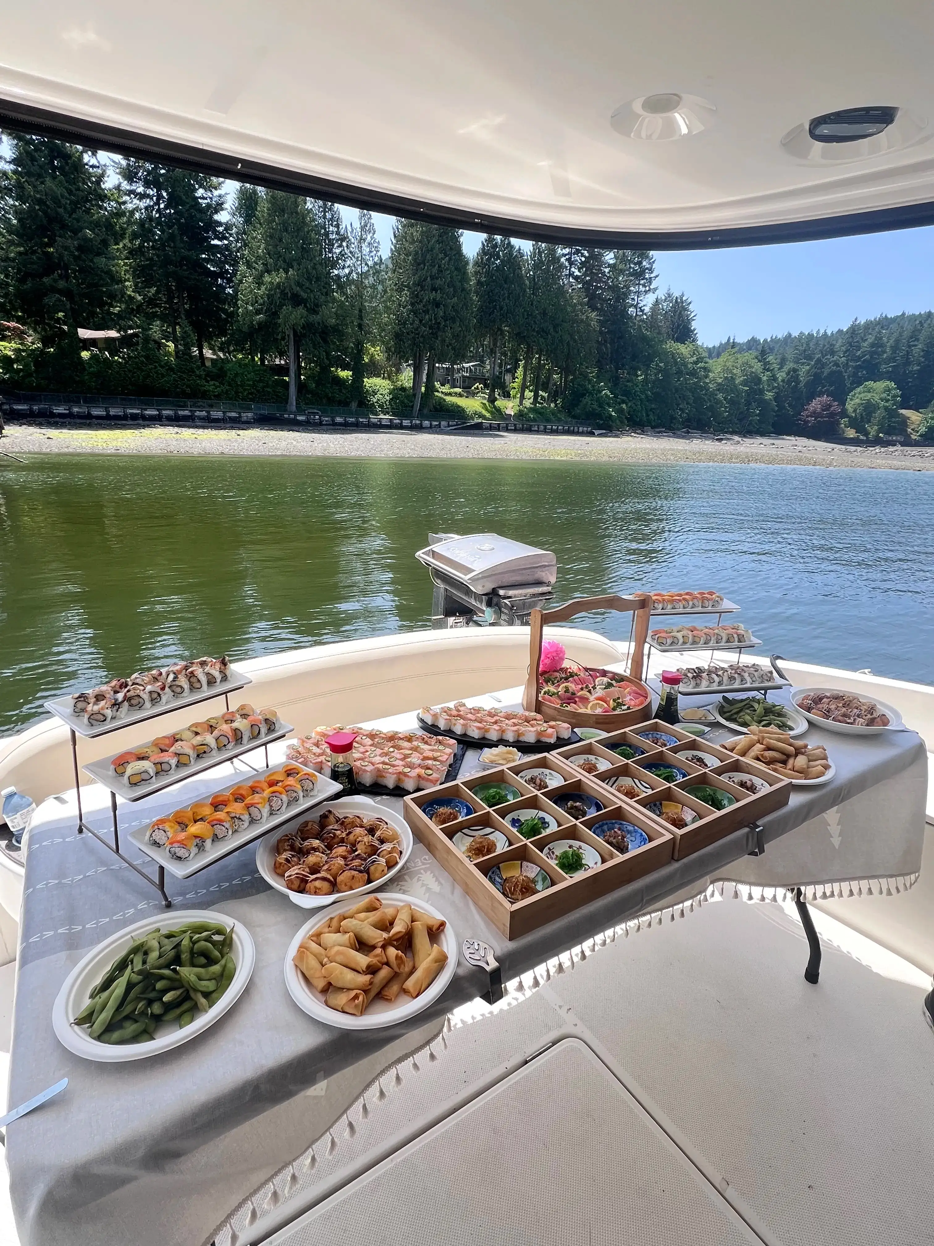 Catered lunch spread aboard a yacht anchored in a quiet forested cove