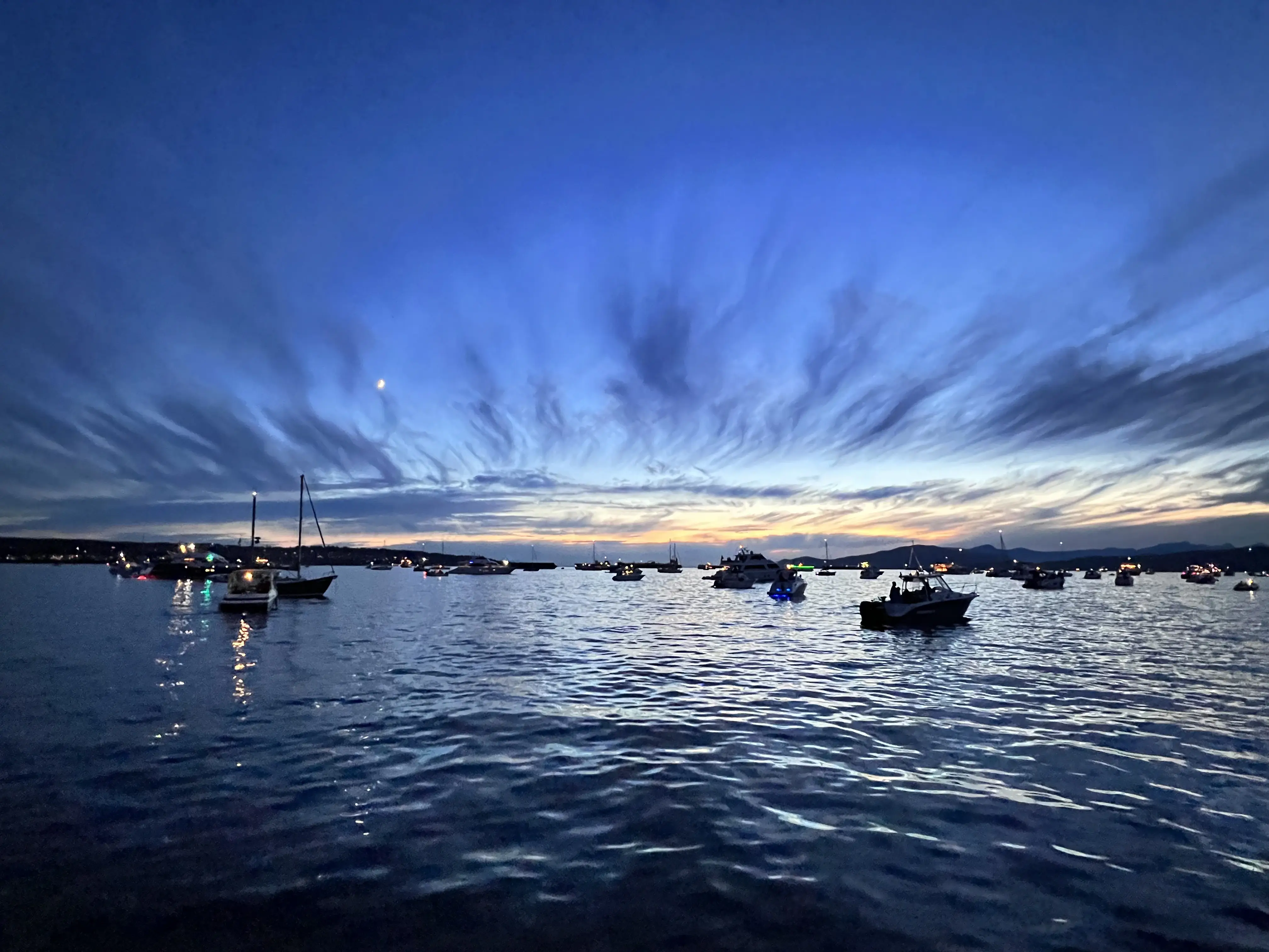 Boats anchored in English Bay under a blue-hour sky